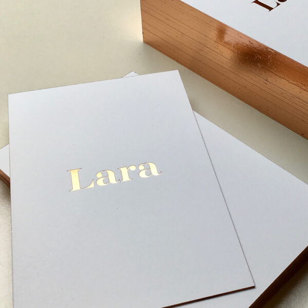 Glanzende geboortekaart met foliedruk op snede