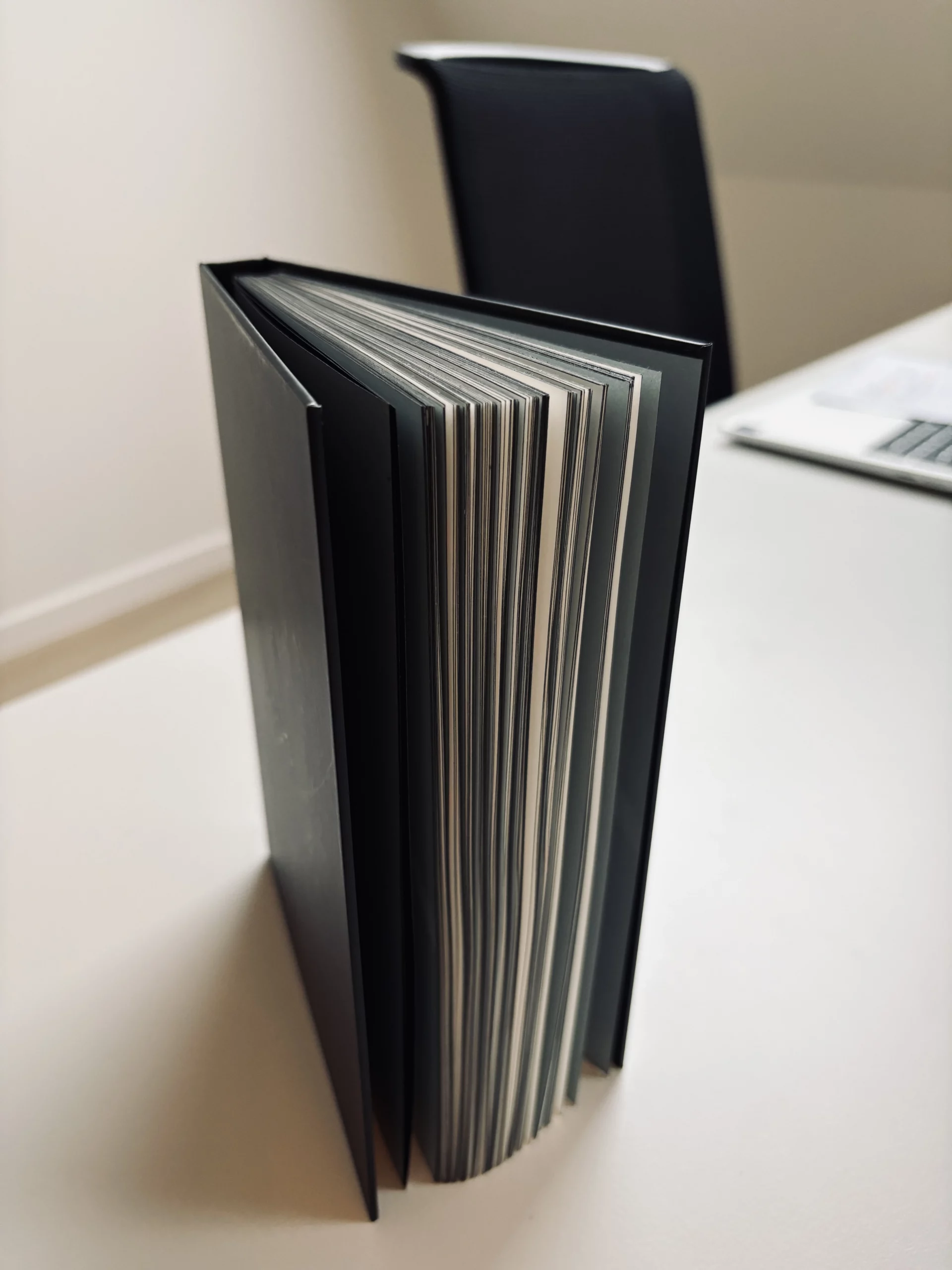 Memo_book with a matt black foil hardcover and matching black-coloured edges.