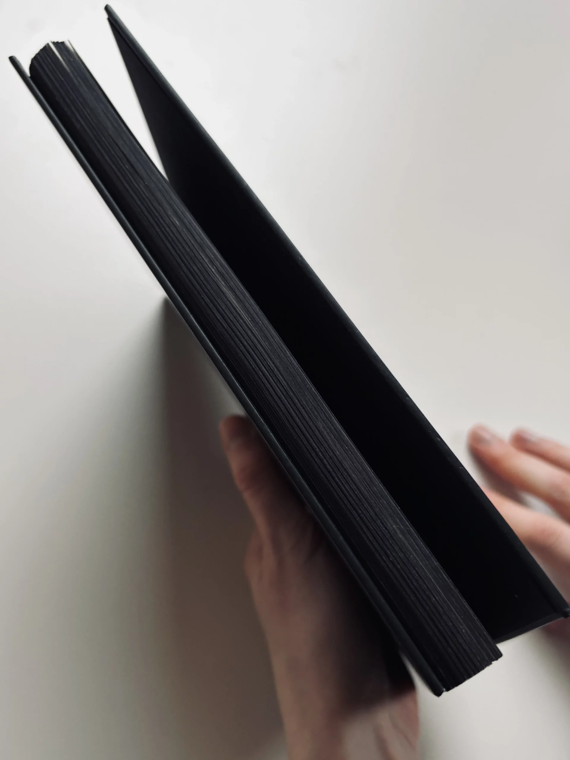 Memo_book with a matt black foil hardcover and matching black-coloured edges.